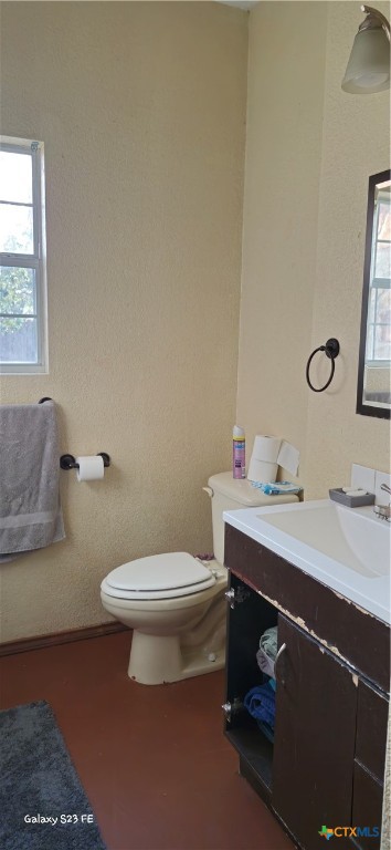 414 Harl Street Pleasanton, TX 78064 - Photo 24 of 28 a bathroom with a toilet a sink and mirror
