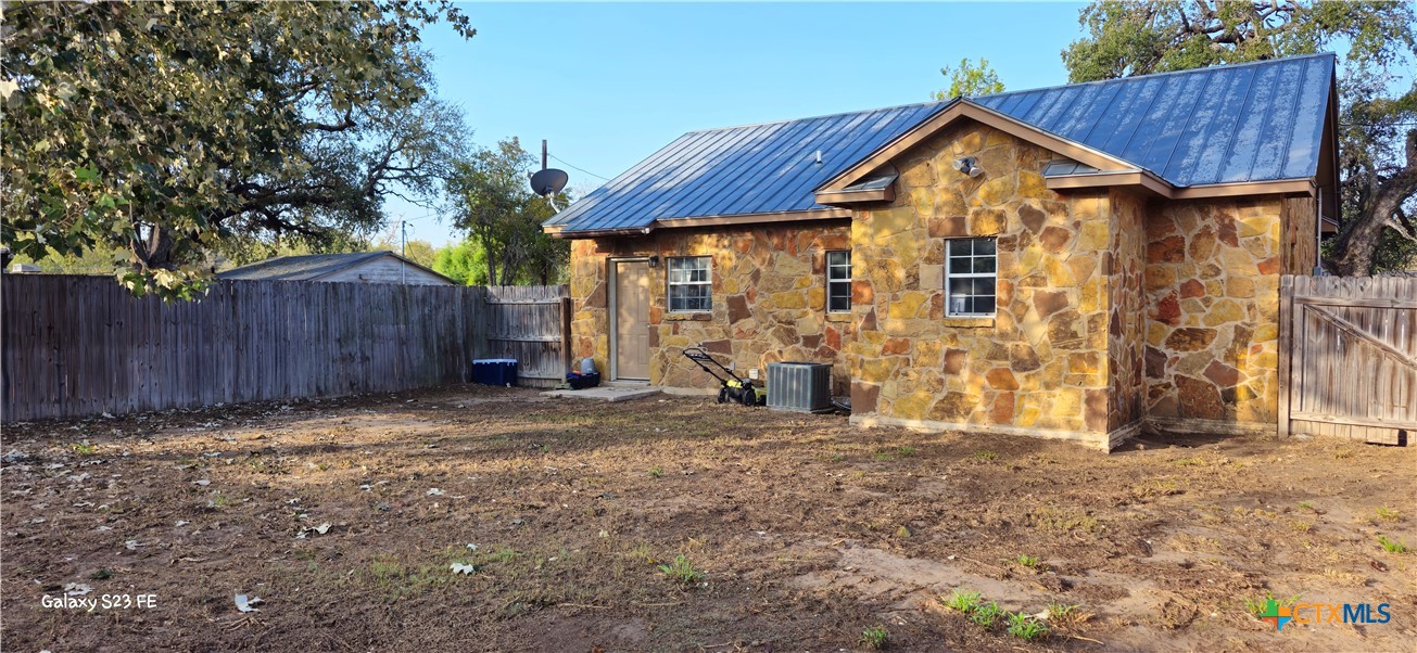 414 Harl Street Pleasanton, TX 78064 - Photo 25 of 28 a view of a house with wooden fence next to a yard