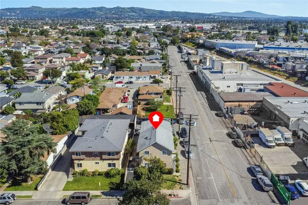 an aerial view of a house with a yard