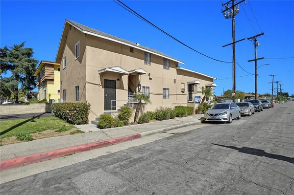 a couple of cars parked in front of a house