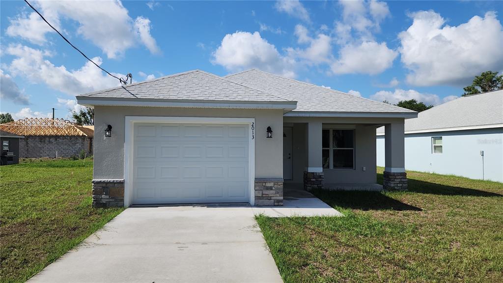 2013 Alderman Road Auburndale, FL 33823 - Photo 1 of 1 a front view of a house with a yard and garage