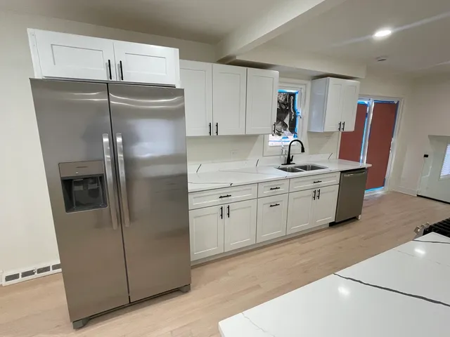 a view of a kitchen with stove and cabinets