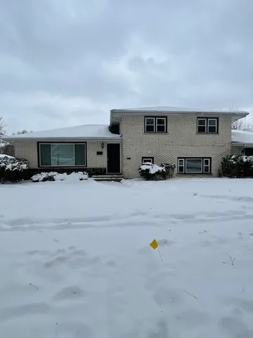 a group of cars parked in front of house