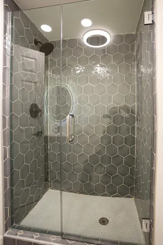 a white house that has a tree in front of it