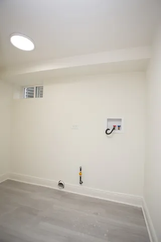 a backyard of a house with a large tree and outdoor seating