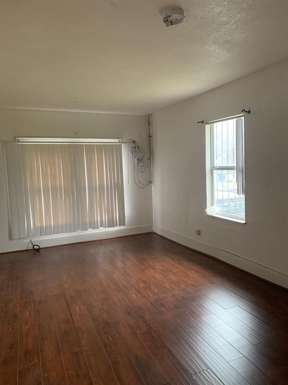 2321 Greer Street Dallas, TX 75215 - Photo 7 of 15 an empty room with wooden floor and windows