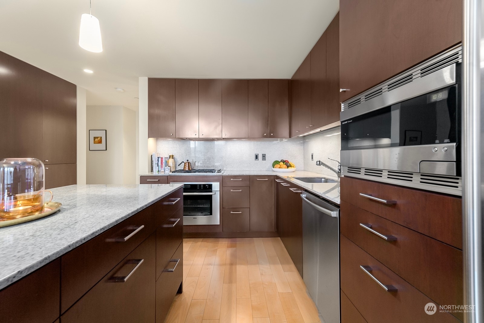 909 5th Avenue, Unit 2103 Seattle, WA 98164 - Photo 13 of 28 a kitchen with a sink stove and microwave
