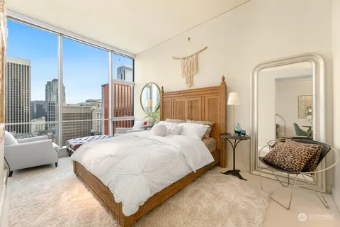 a bedroom with a bed couch and a view of bedroom