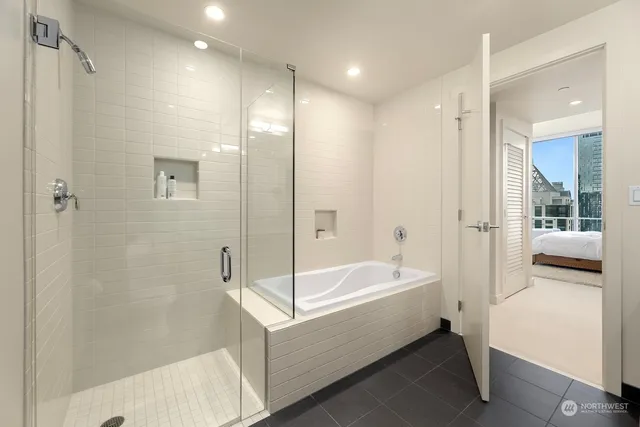 a bathroom with a bathtub and a shower