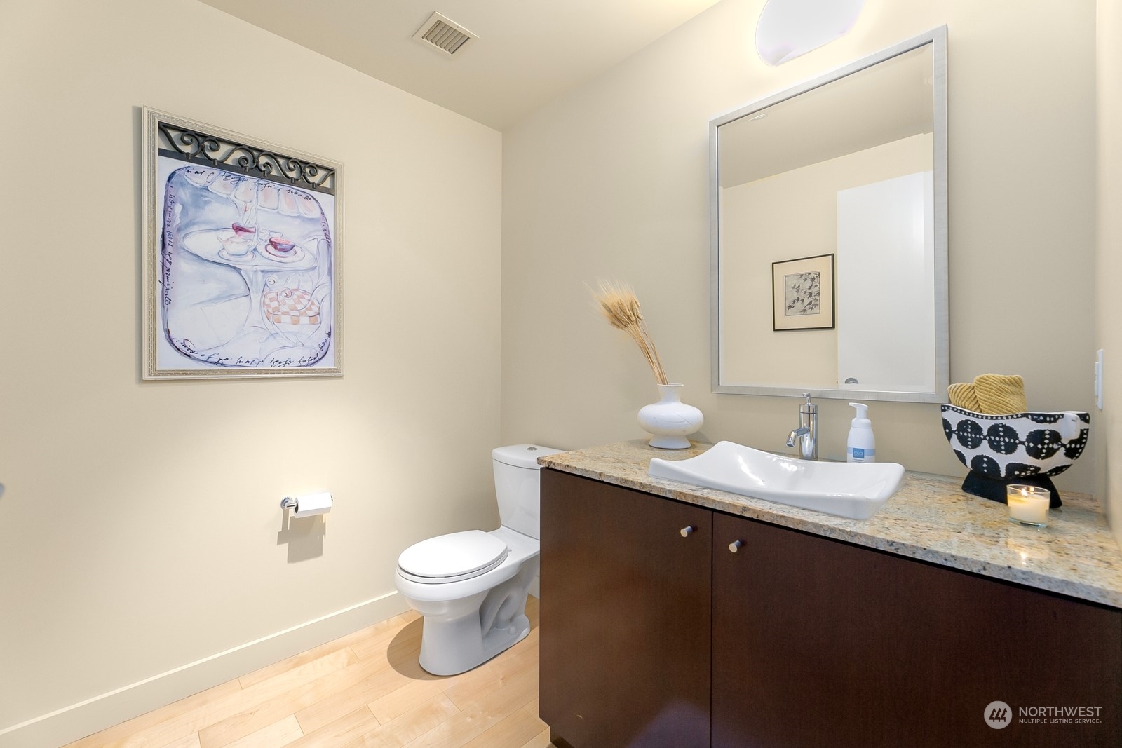 909 5th Avenue, Unit 2103 Seattle, WA 98164 - Photo 24 of 28 a bathroom with a granite countertop sink a toilet and a mirror