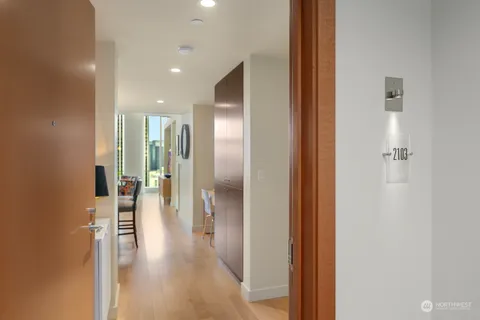 a view of a hallway with wooden floor