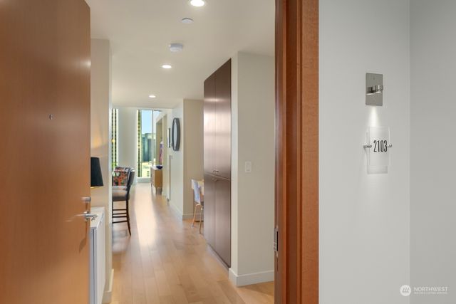 a view of a hallway with wooden floor