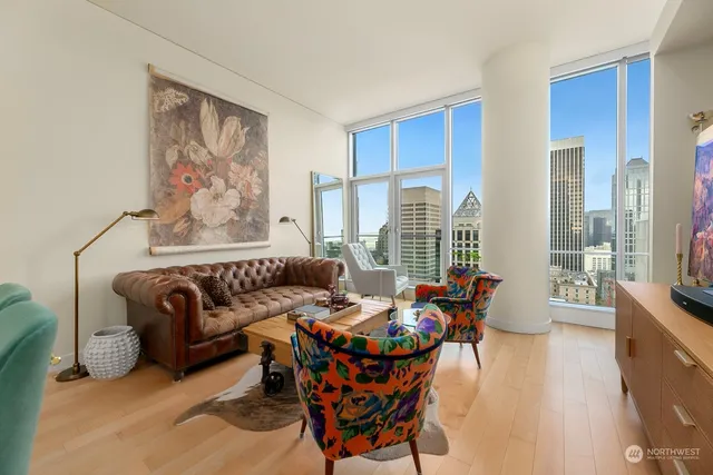 a living room with furniture and floor to ceiling windows