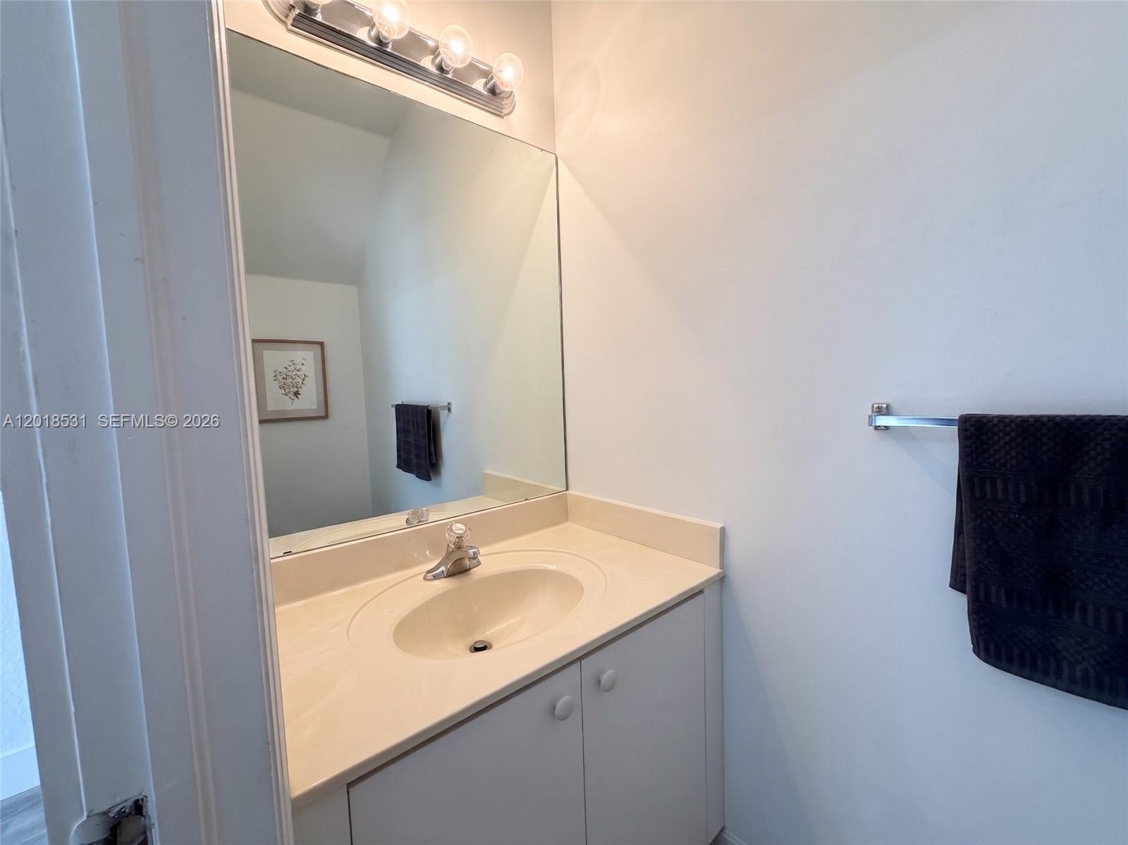 1575 Southeast 20th Road Homestead, FL 33035 - Photo 6 of 19 a bathroom with a sink and a mirror