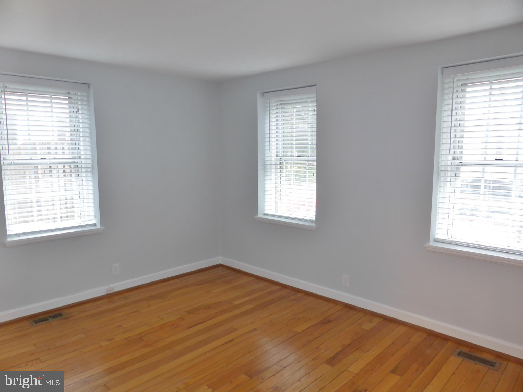 2916 South Buchanan Street, Unit A2 Arlington, VA 22206 - Photo 11 of 19 a view of an empty room with wooden floor and a window