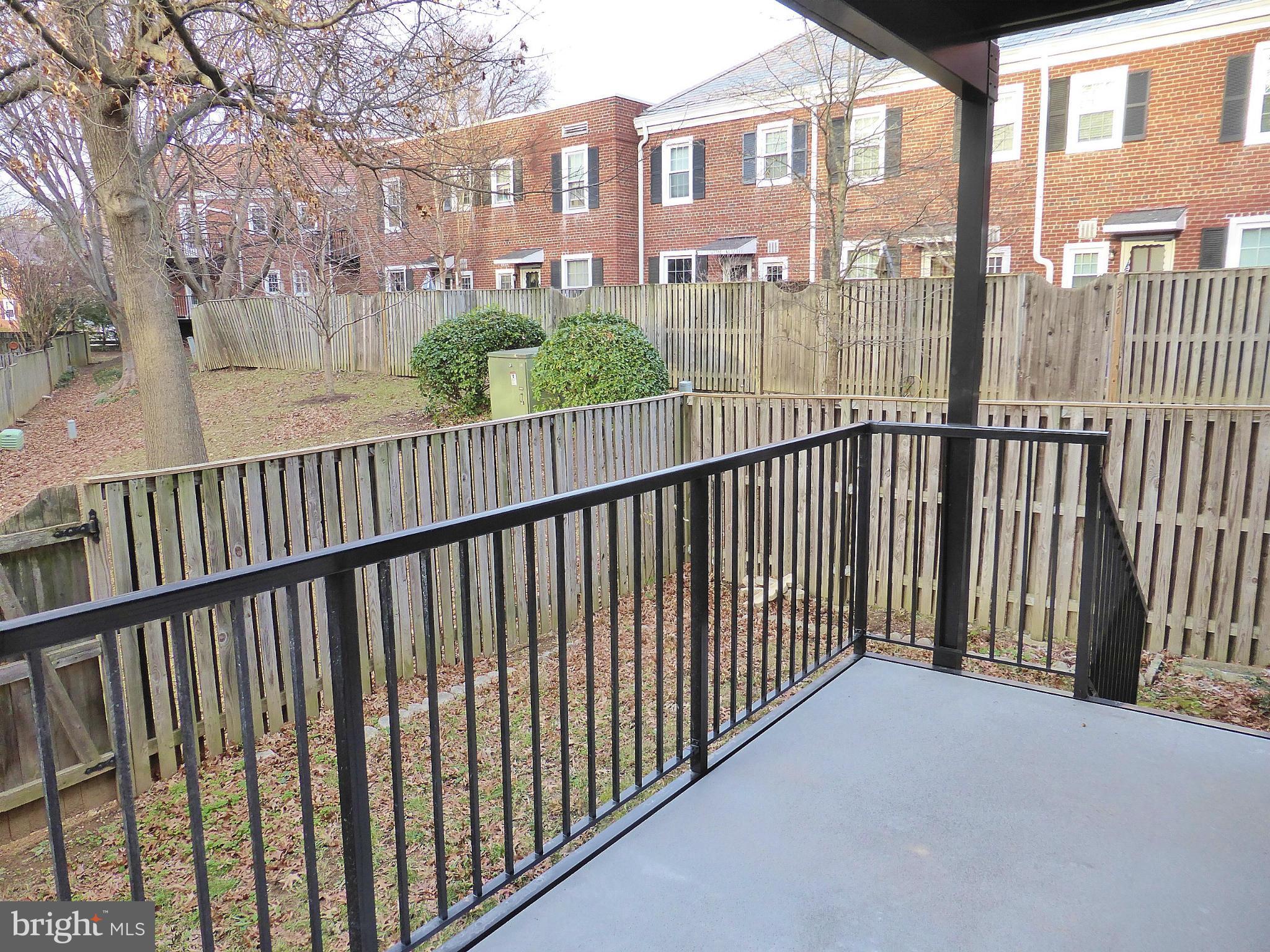 2916 South Buchanan Street, Unit A2 Arlington, VA 22206 - Photo 17 of 19 a view of a balcony with a floor to ceiling window and wooden fence