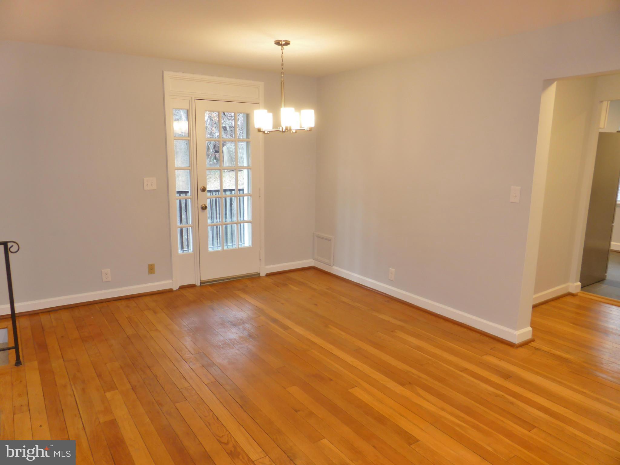 2916 South Buchanan Street, Unit A2 Arlington, VA 22206 - Photo 9 of 19 a view of an empty room with wooden floor and a window