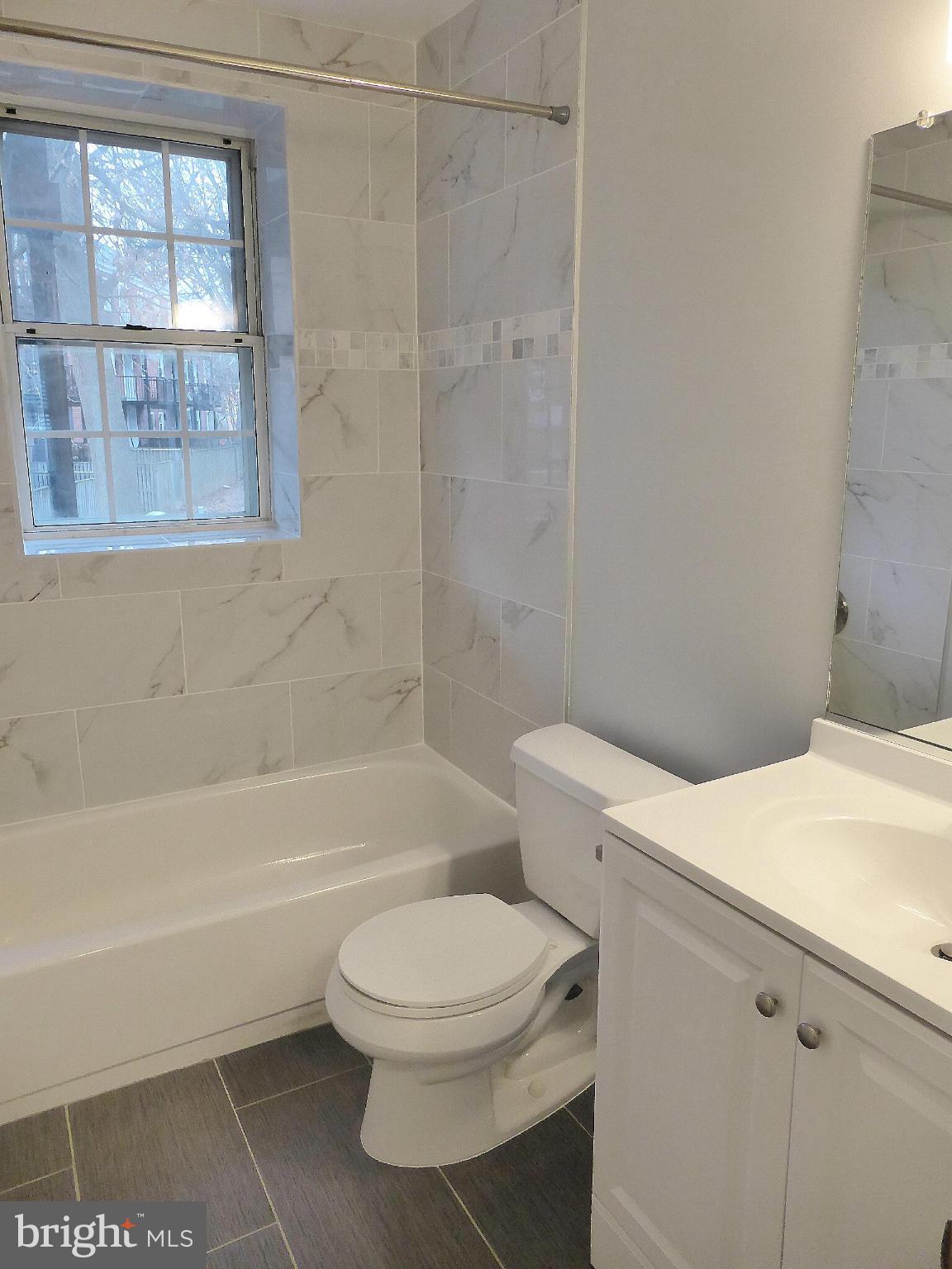 2916 South Buchanan Street, Unit A2 Arlington, VA 22206 - Photo 10 of 19 a bathroom with a toilet a sink and a bathtub