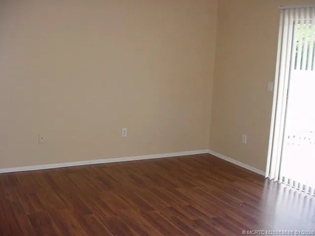 a view of a room with wooden floor