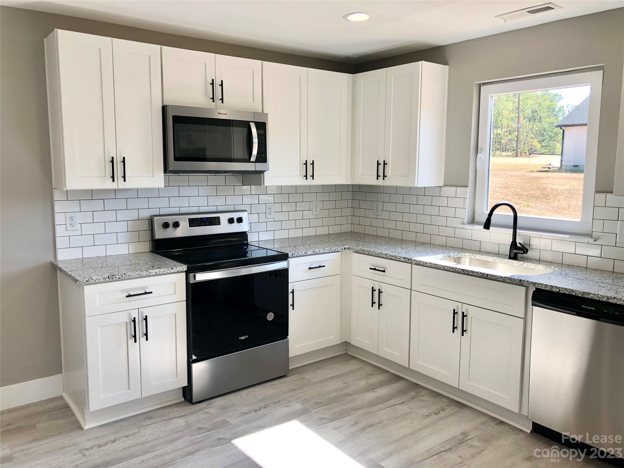 2379 Laboratory Road Lincolnton, NC 28092 - Photo 4 of 19 a kitchen with a sink stove and microwave