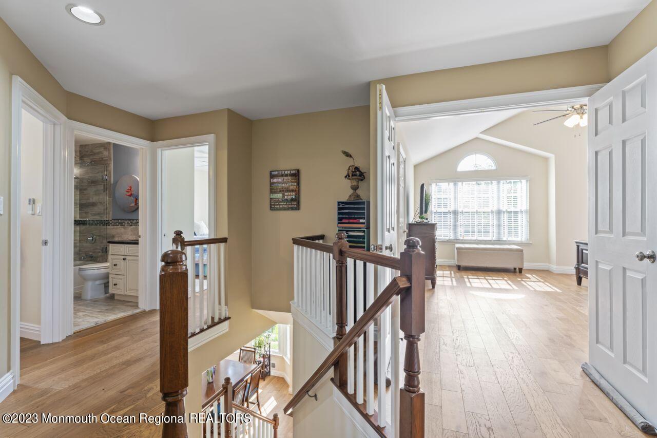 18 Nicholson Key Colts Neck, NJ 07722 - Photo 18 of 46 a view of a hallway with wooden floor and staircase