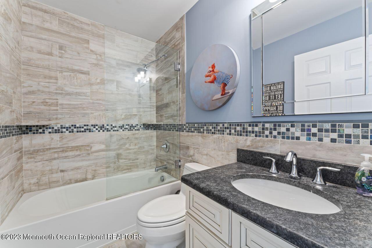 18 Nicholson Key Colts Neck, NJ 07722 - Photo 27 of 46 a bathroom with a granite countertop sink and a mirror