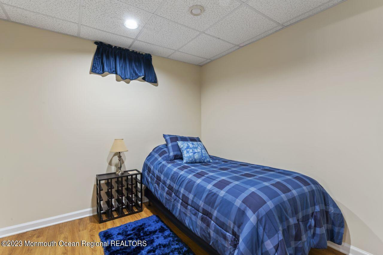 18 Nicholson Key Colts Neck, NJ 07722 - Photo 31 of 46 a bedroom with a bed a rug and a wall painting