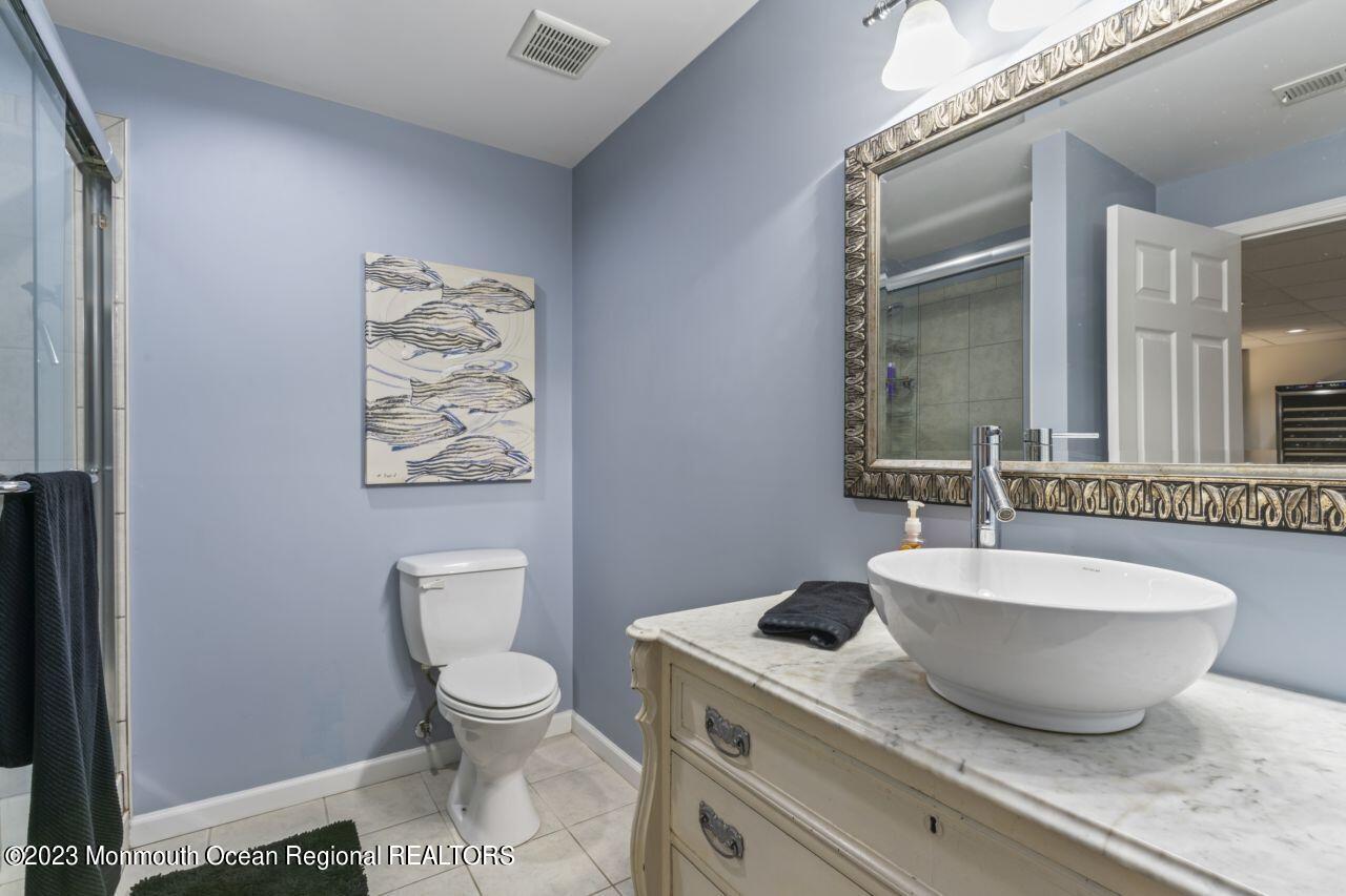 18 Nicholson Key Colts Neck, NJ 07722 - Photo 33 of 46 a spacious bathroom with a toilet a sink and a mirror