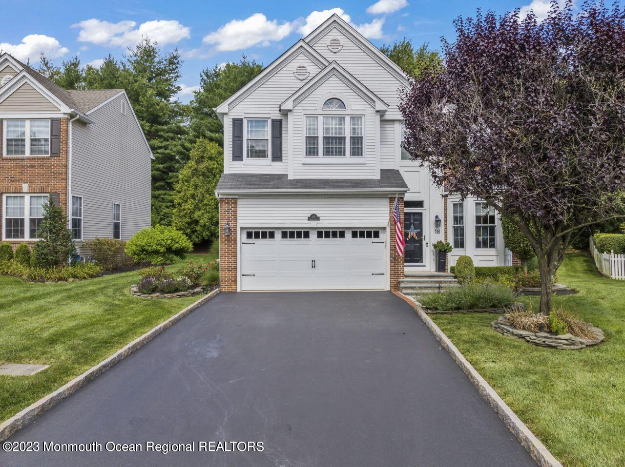18 Nicholson Key Colts Neck, NJ 07722 - Photo 41 of 46 a view of a white house with a yard and large tree