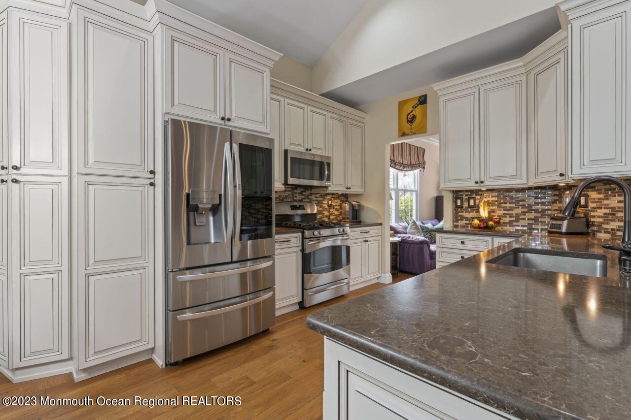 18 Nicholson Key Colts Neck, NJ 07722 - Photo 9 of 46 a kitchen with granite countertop a refrigerator stove and microwave