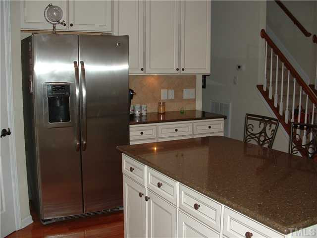 1908 Grace Point Road Morrisville, NC 27560 - Photo 6 of 22 Notice the beautiful tile backsplash;Granite like countertops(Zodiac) which are easier than Granite and more durable.Under cabinet lighting and hardwood floors make this kitchen a wonderful area to cook! Kitchen