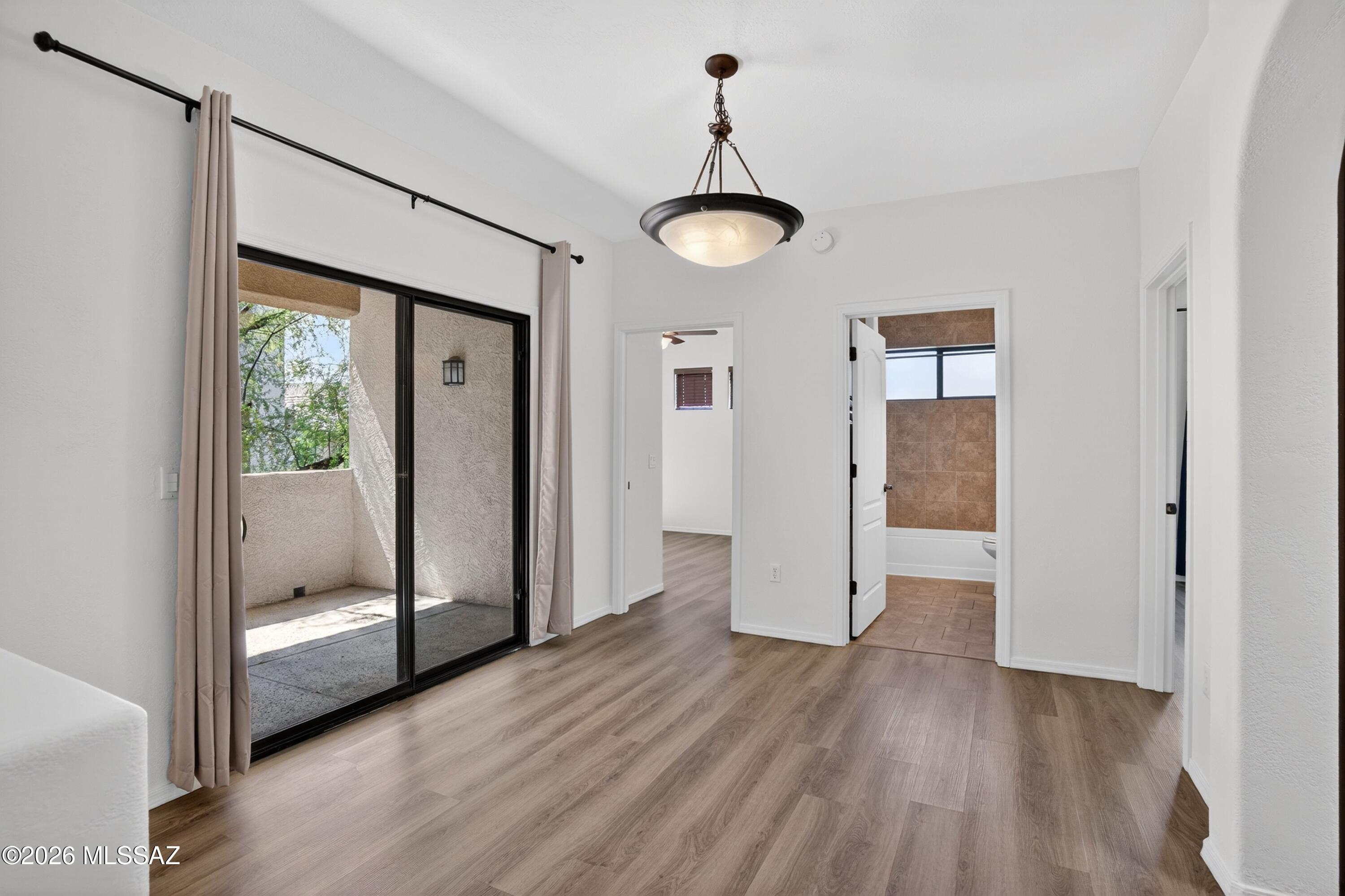 2550 East River Road, Unit 4204 Tucson, AZ 85718 - Photo 11 of 36 a view of a room with wooden floor and door