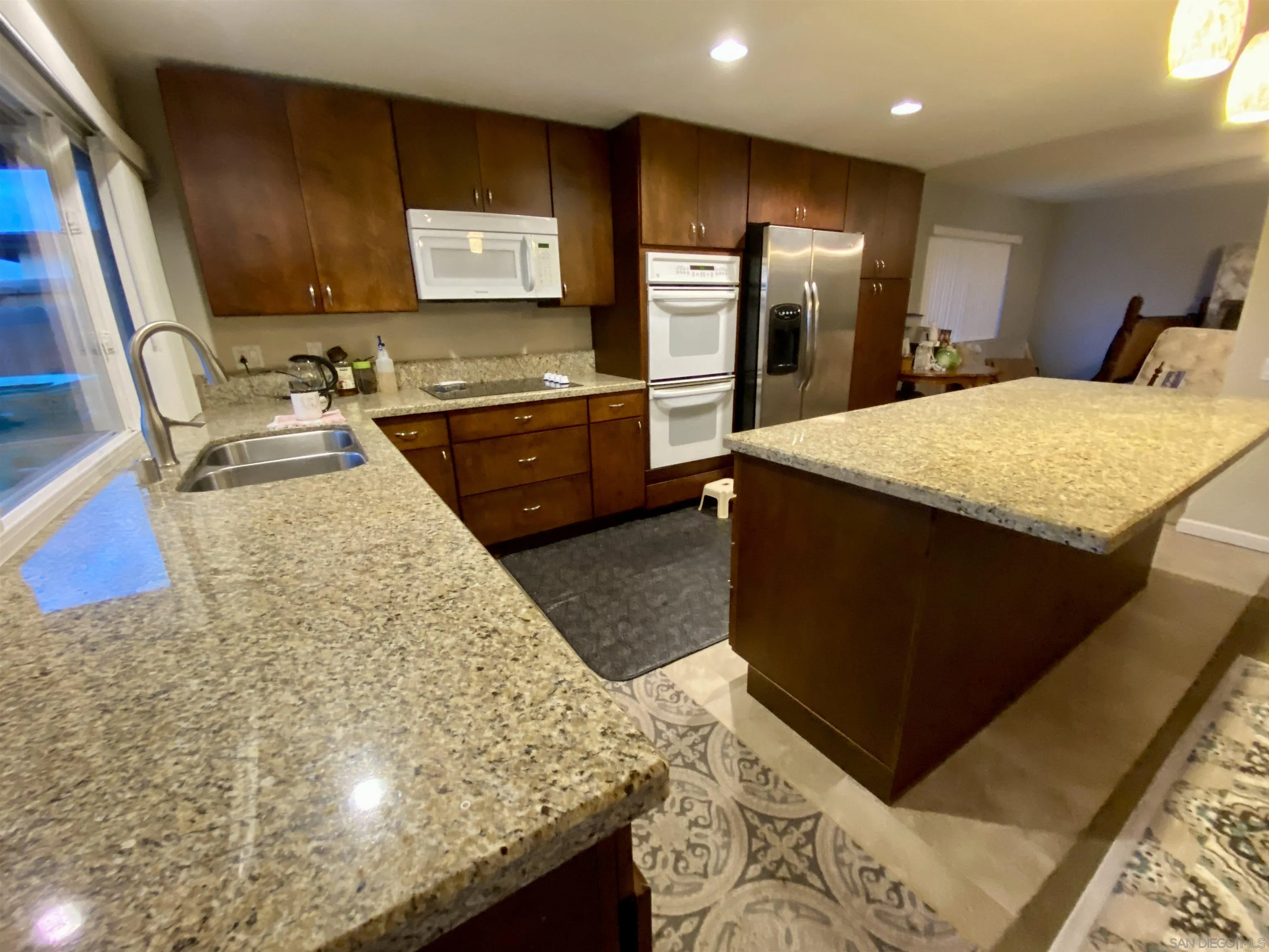12608 Mantilla Road San Diego, CA 92128 - Photo 3 of 37 a kitchen with stainless steel appliances kitchen island granite countertop a sink stove and refrigerator