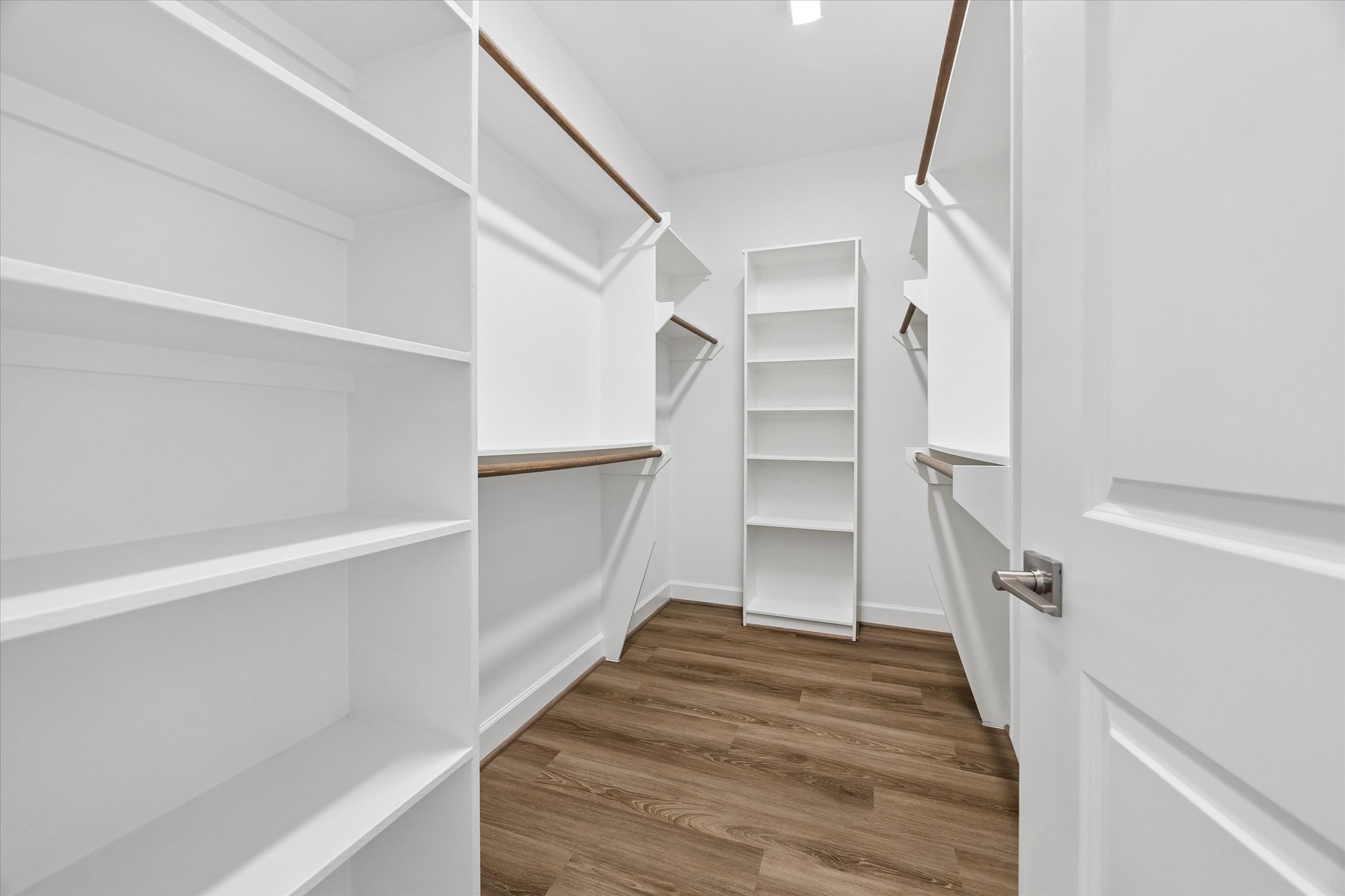 603 Link Road, Unit F Houston, TX 77009 - Photo 18 of 37 Oversized primary walk-in closet offers extensive built-in shelving and hanging space. Thoughtful storage makes excellent use of the closet’s generous footprint.