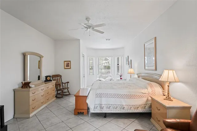 a bedroom that has a bed and a desk in it