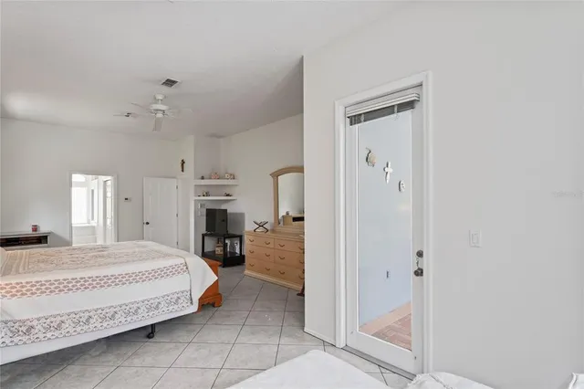 a bathroom with a granite countertop double vanity sink a mirror and a toilet