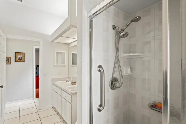a front view of a house with a yard and potted plants