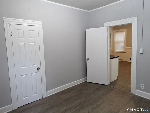 an empty room and wooden door