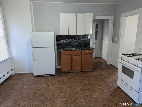 a kitchen with granite countertop a refrigerator stove a sink and dishwasher