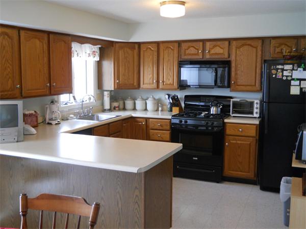 96 Century Way, Unit 96 Gardner, MA 01440 - Photo 2 of 10 a kitchen with a sink a stove and a cabinets