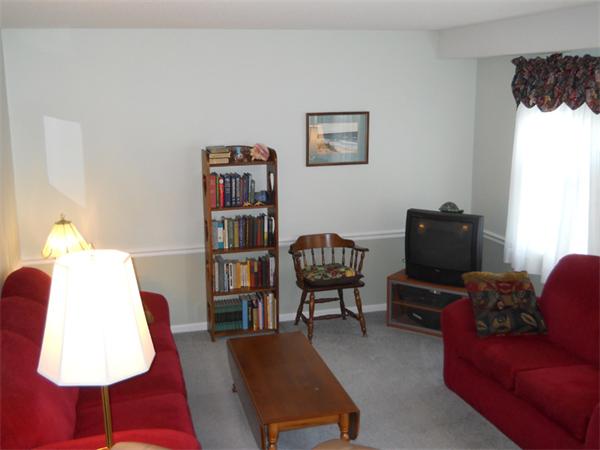 96 Century Way, Unit 96 Gardner, MA 01440 - Photo 5 of 10 a living room with furniture and a book shelf