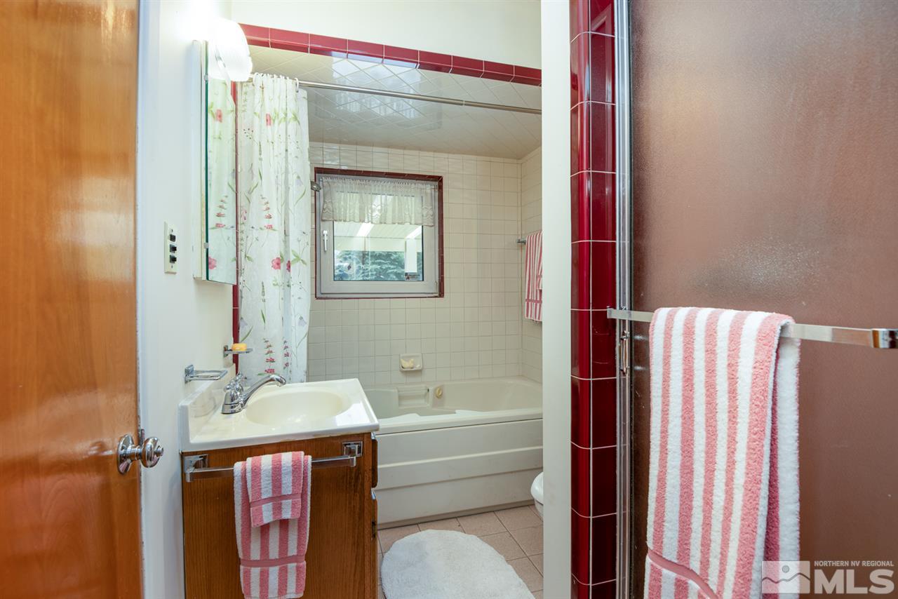 1270 Tacoma Way Reno, NV 89509 - Photo 17 of 24 a bathroom with a sink vanity mirror and toilet