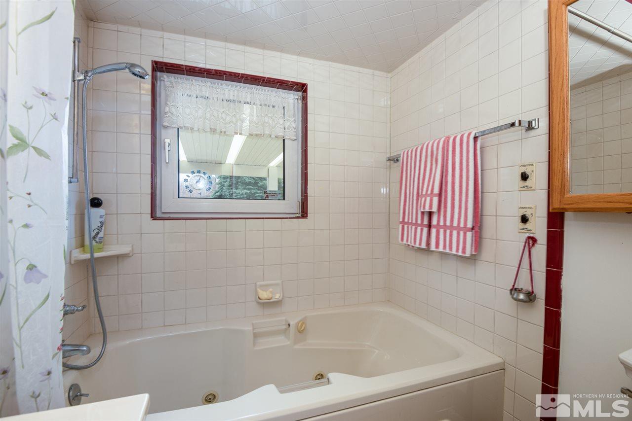 1270 Tacoma Way Reno, NV 89509 - Photo 18 of 24 a white bath tub sitting next to a shower