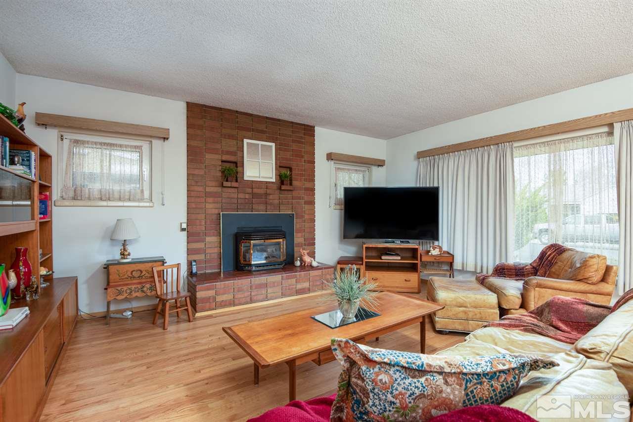 1270 Tacoma Way Reno, NV 89509 - Photo 4 of 24 a living room with furniture a flat screen tv and a fireplace