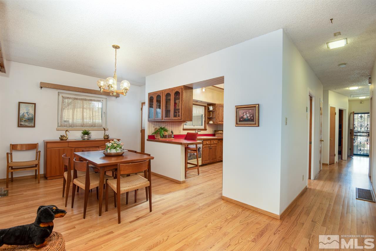 1270 Tacoma Way Reno, NV 89509 - Photo 5 of 24 a open kitchen with stainless steel appliances kitchen island granite countertop a table and chairs in it