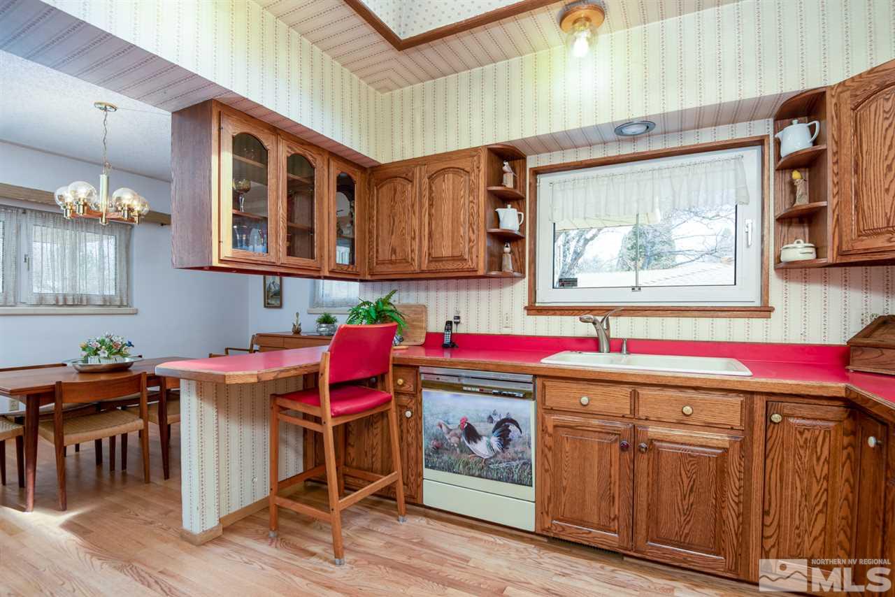 1270 Tacoma Way Reno, NV 89509 - Photo 7 of 24 a kitchen with stainless steel appliances granite countertop a stove and cabinets