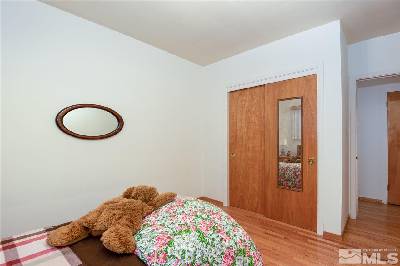 1270 Tacoma Way Reno, NV 89509 - Photo 9 of 24 a bedroom with a bed and wooden floor