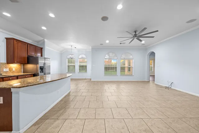 a view of a kitchen with stainless steel appliances granite countertop a stove and a sink
