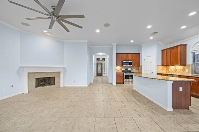 a kitchen with granite countertop cabinets stainless steel appliances and a sink