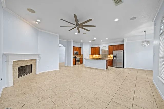 an empty room with windows and chandelier